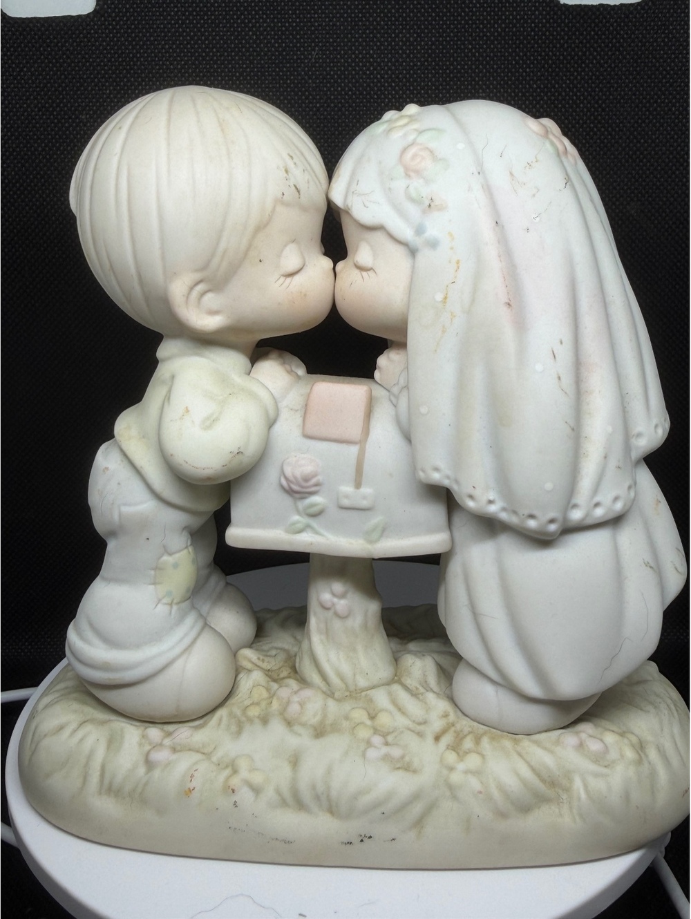 Bride and groom kissing figurine
